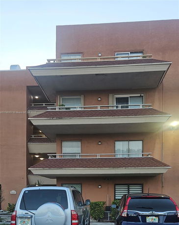 Front view of a multi-story residential building with balconies.
