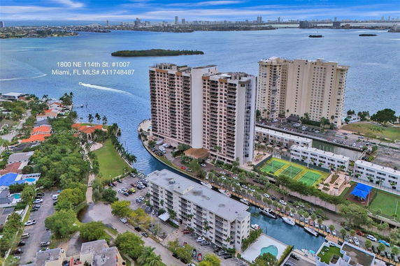 Aerial view of a waterfront apartment complex with multiple high-rise buildings and surrounding waterways.