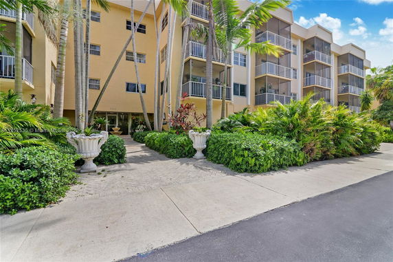 Front view of a multi-story residential building with balconies.