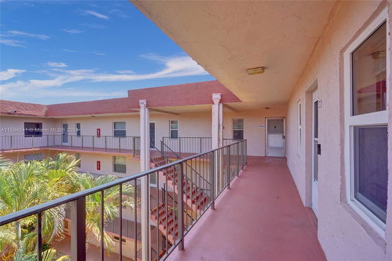 View of an apartment complex with balconies and staircases.