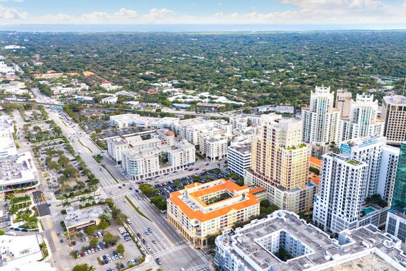 Aerial panoramic view of a cityscape with multiple high-rise buildings and surrounding areas.