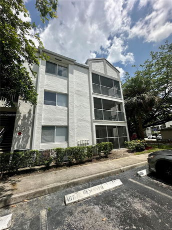 Front view of a three-story apartment building with balconies.