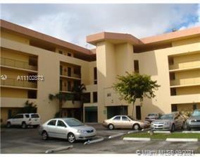 Outdoor parking area in front of a multi-story building.
