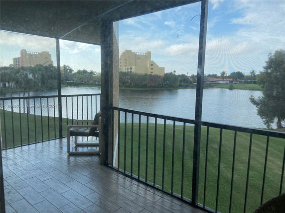 View from a balcony overlooking a lake and buildings.