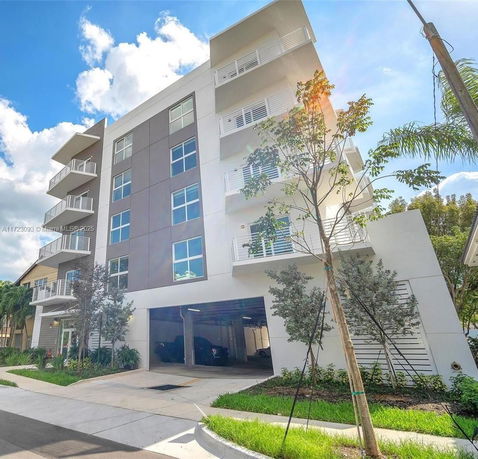 Front view of a modern multi-story building with balconies.