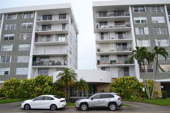 Front view of a multi-story residential building with balconies.