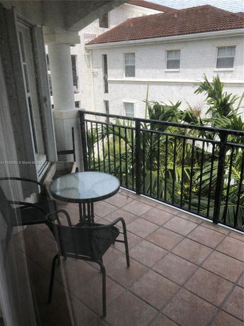 View from a balcony showing a neighboring building with a tiled roof.