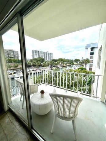 Balcony view showing a waterway and surrounding buildings.