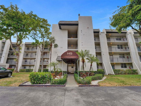 Front view of a multi-story apartment building with balconies.
