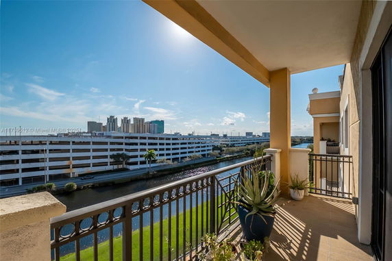 View from an apartment balcony overlooking a canal and urban area.