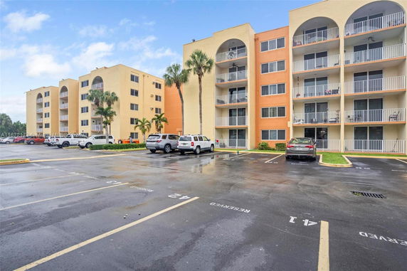 Apartment buildings with designated parking spaces in front.
