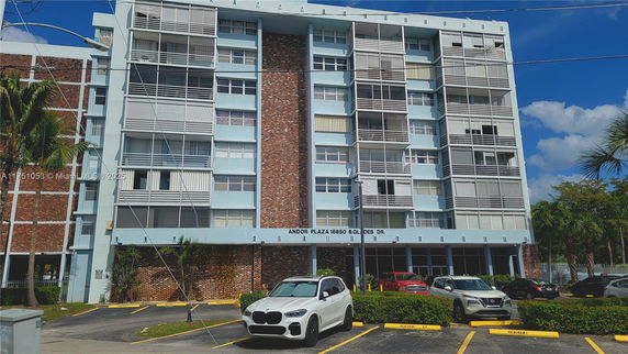 Front view of a multi-story residential building with balconies.