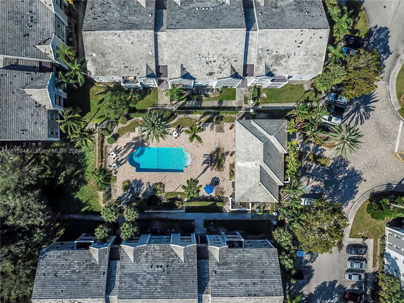 Aerial view of a residential area with a central swimming pool surrounded by buildings.