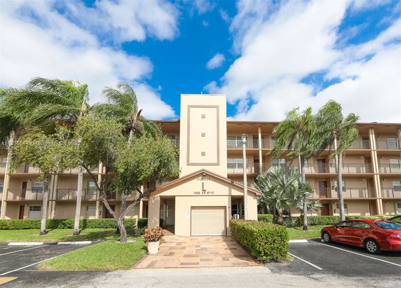 Front view of a multi-story apartment building with balconies.