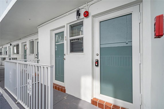 Front view of a building with white doors and railings.
