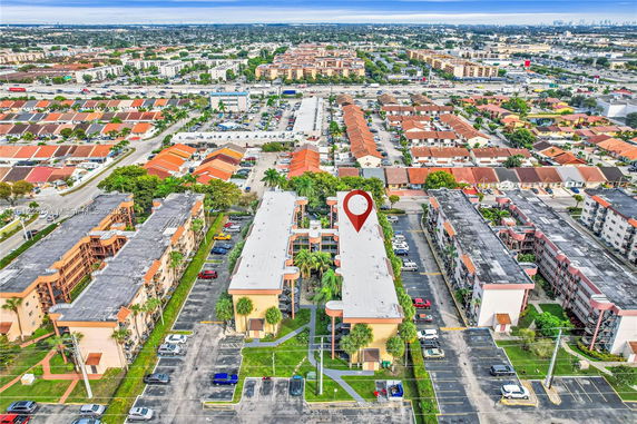 Aerial view of a residential area with apartment buildings and surrounding houses.