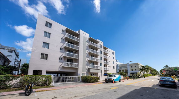 Front view of a multi-story residential building with balconies.