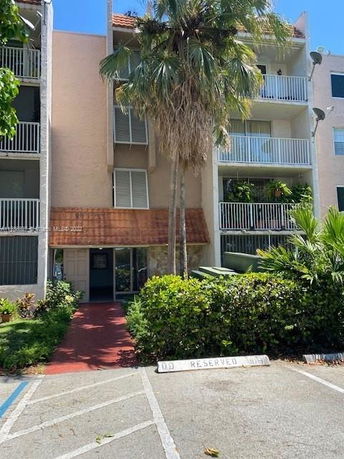 Front view of a multi-story residential building with balconies.