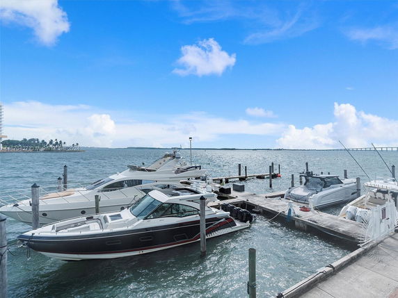 View of a marina with boats docked by the waterfront.