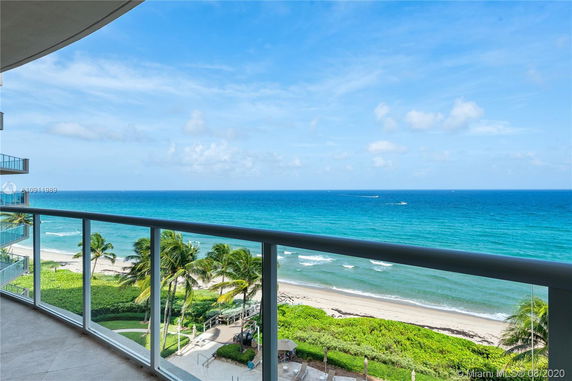 Panoramic view from a balcony overlooking the ocean.