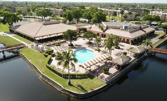 Aerial view of a large building complex with swimming pool and surrounding outdoor area.