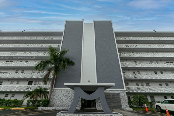 Front view of a multi-story building with unique architectural design.