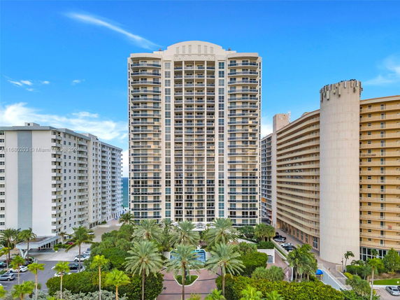 Front view of a high-rise residential building with balconies.