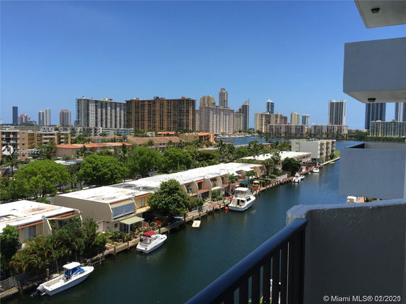 Panoramic view of cityscape with a waterway and boats.