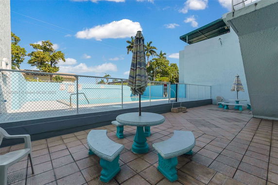 Outdoor area with a swimming pool and seating arrangement.