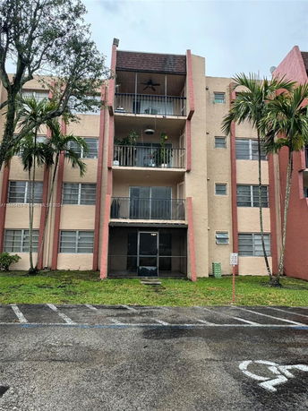 Front view of a multi-story apartment building with balconies.