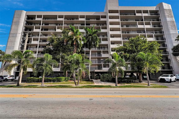 Front view of a multi-story residential building with balconies.
