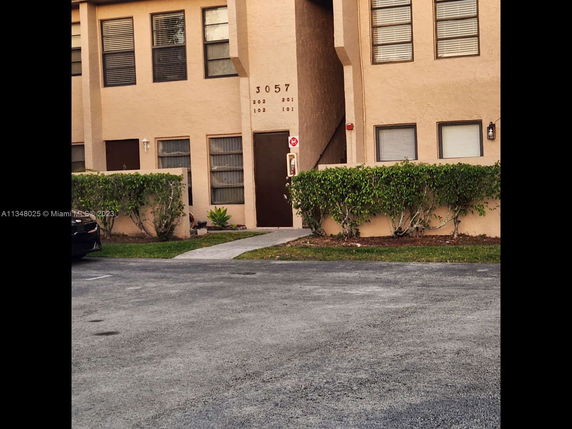 Front view of a two-story residential building with visible entrance.