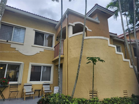 Front view of a two-story house with a decorative exterior wall design.
