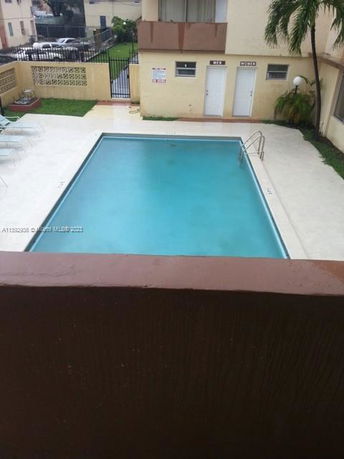 Outdoor swimming pool area beside a building.