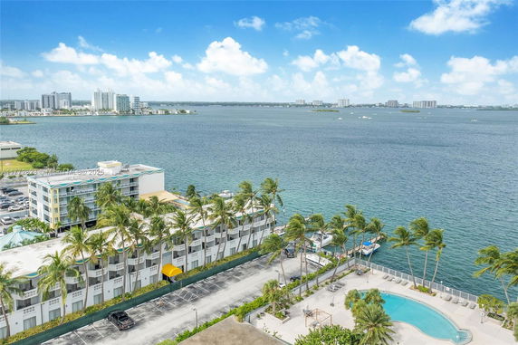Panoramic view of coastal area with buildings and a swimming pool.