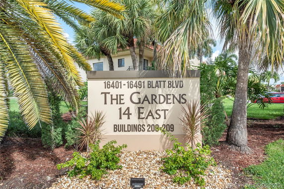 Front view of a building with a sign reading 'The Gardens 14 East' at 16401-16491 Blatt Blvd.