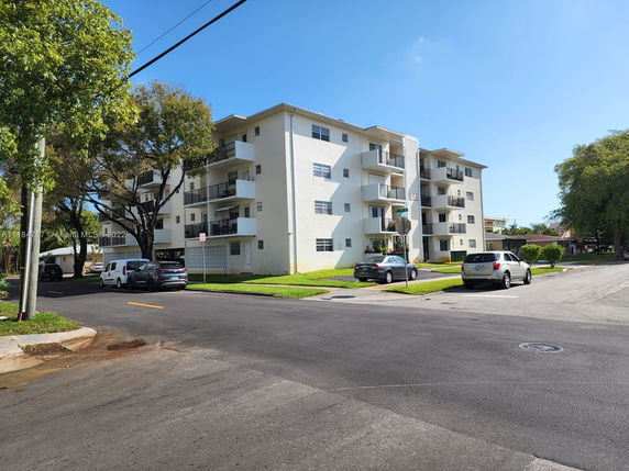 Front view of a multi-story apartment building with balconies.