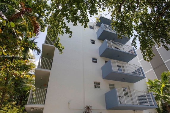 Front view of a multi-story building with multiple balconies.