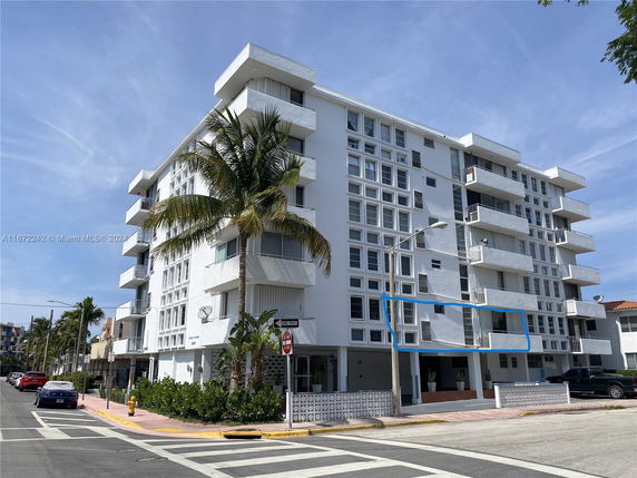 Front view of a multi-story apartment building with balconies.