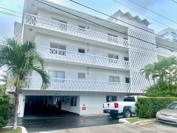 Front view of a multi-story building with balconies.