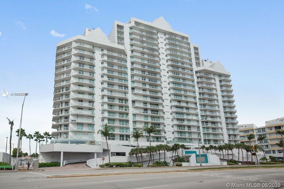 Front view of a multi-story apartment building with balconies.