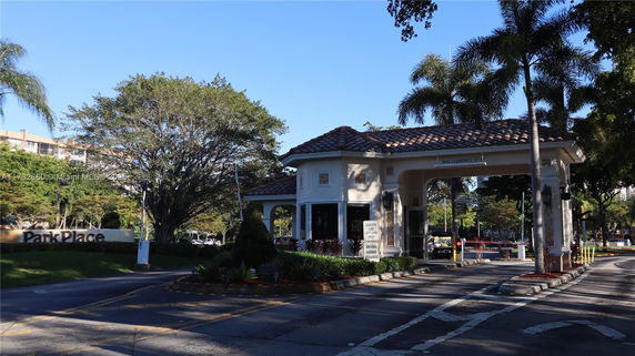 Entrance gatehouse with tiled roof and driveway.