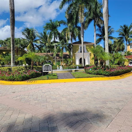 Front view of a large building with decorative entrance and landscaping.