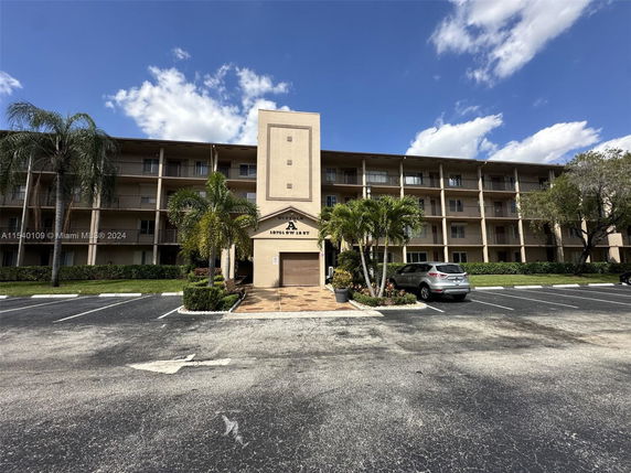 Front view of a multi-story residential building with balconies.