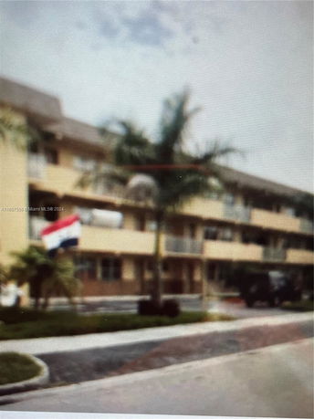 Front view of a multi-story building with balconies.