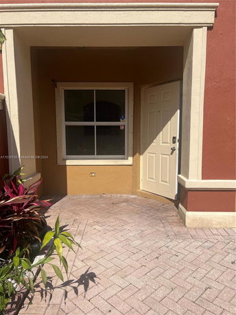 Front view of a house entrance with a window and a door.