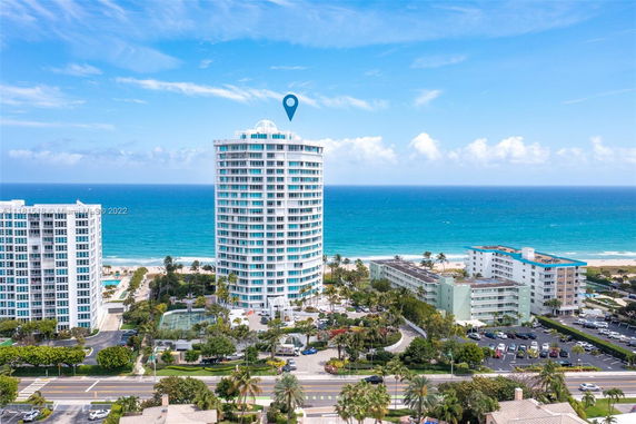 Aerial view of a coastal high-rise building with ocean in the background.
