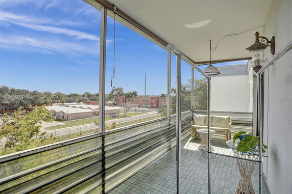 View from a balcony overlooking surrounding areas with a clear sky.