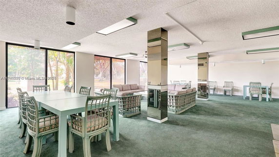 Interior view of a recreational area with tables, chairs, and seating.