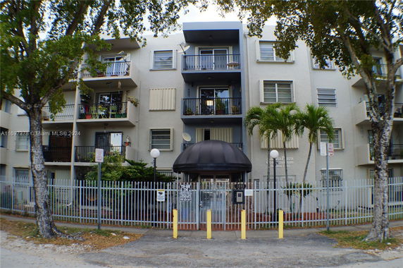 Front view of a multi-story residential building with balconies.